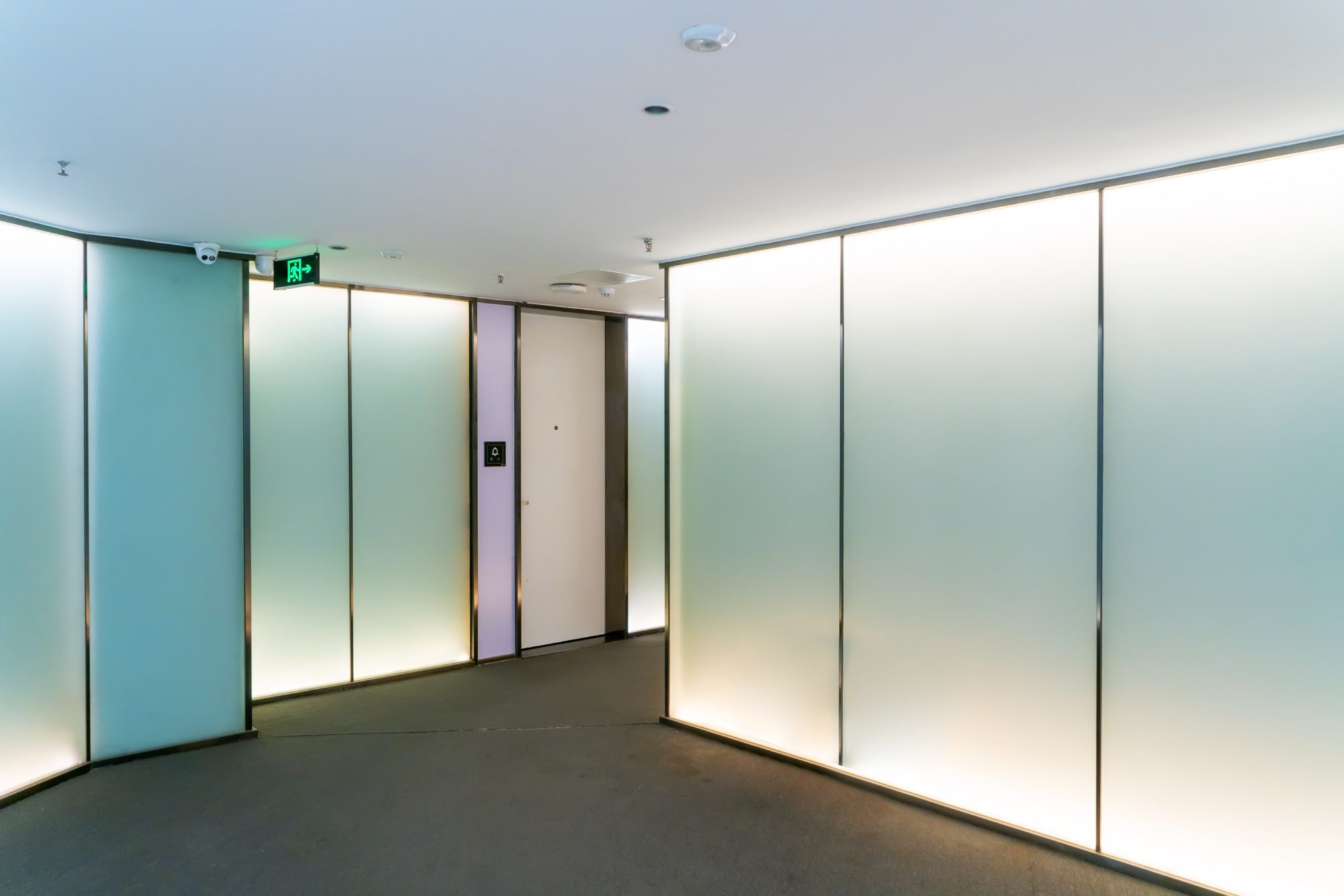 Modern corridor with illuminated frosted glass.